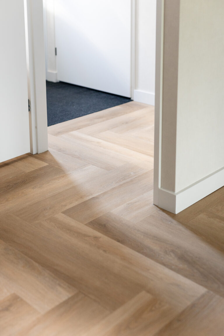 private label pvc vloer gelegd in elleboogpatroon doorlopend in hal met droogloopmat